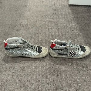 Golden Goose mid-top sneakers with glitter, leather, and seude.